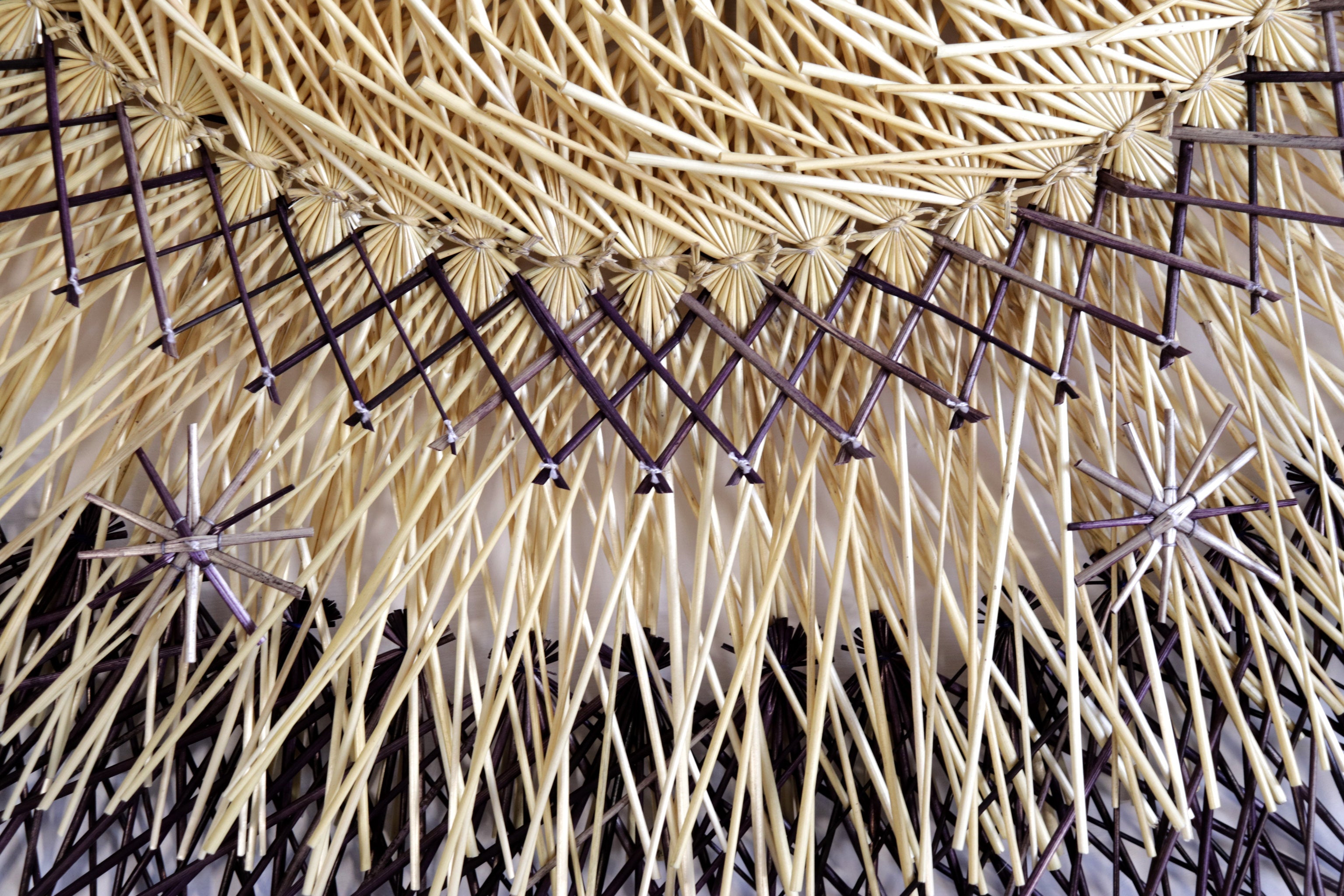 Large 40 in. hand-woven wheat straw wall circle, black and copper design, Michoacán folk art