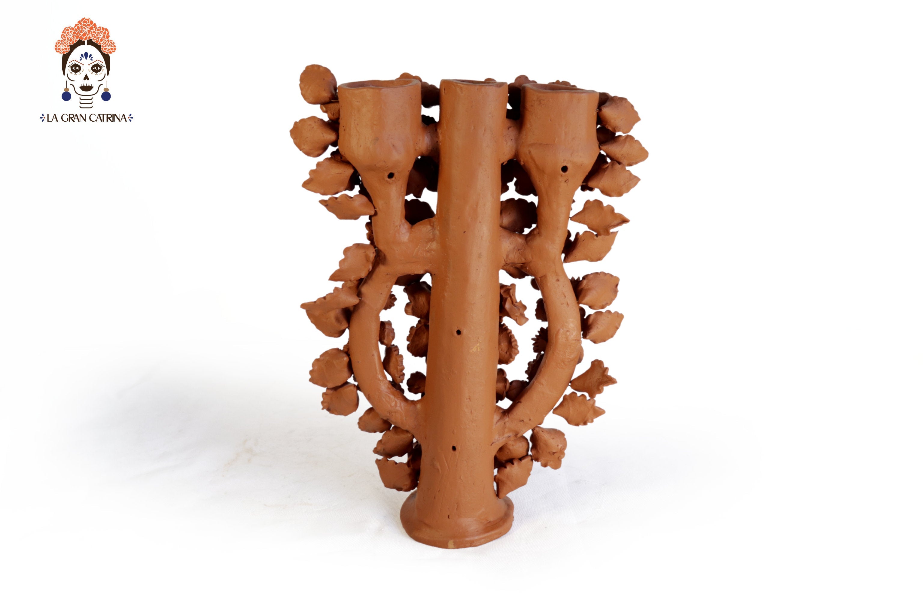 Natural clay candelabra covered in hand-shaped flowers and roses, Mexican folk art